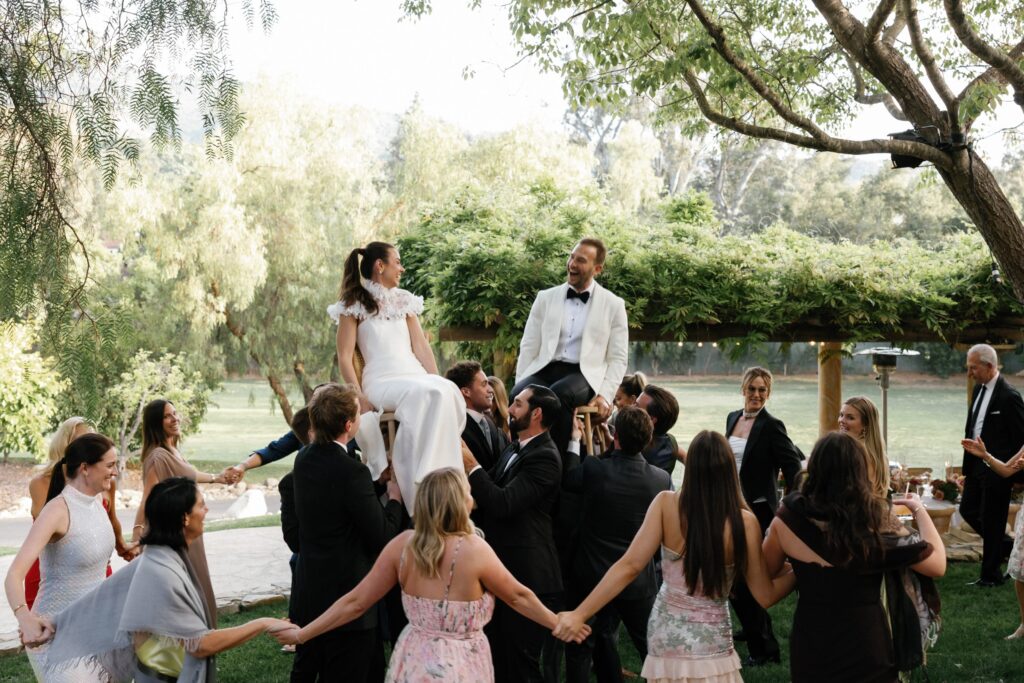 Wedding guests dance around the bride and groom at Ojai Valley Inn wedding reception