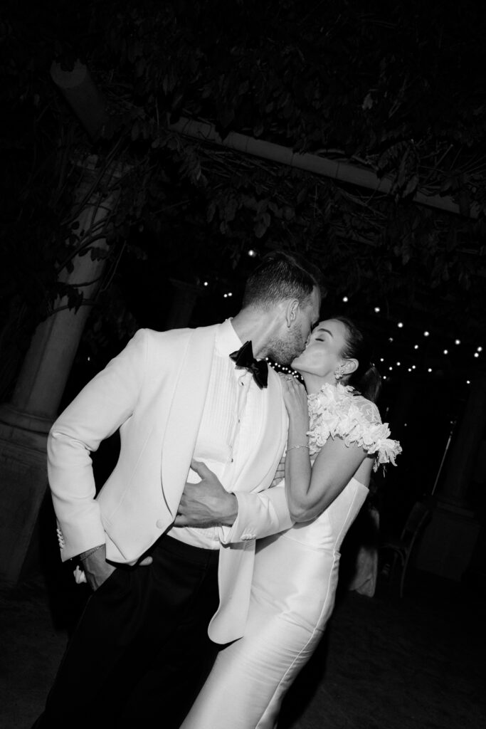 Bride and groom kiss at their Ojai Valley Inn wedding reception